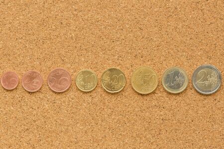 euro coins collection isolated on cork board background
