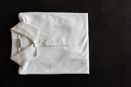 Top view of new white Polo Shirt on dark deerskin backgroundの写真素材