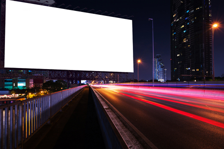 blank billboard on light trails, street, city and urban in the night - can advertisement for display or montage product or businessの写真素材