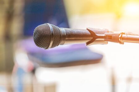 Microphone on abstract blurred indoor background with sunlight of sunsetの写真素材