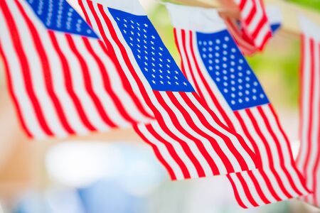 American (USA) flag waving isolated on nature background as country leader concept.の写真素材