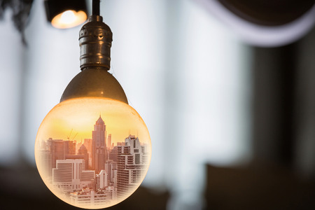cityscape at sunset in the big circle light bulb as business, globalization, think and idea concept.の写真素材