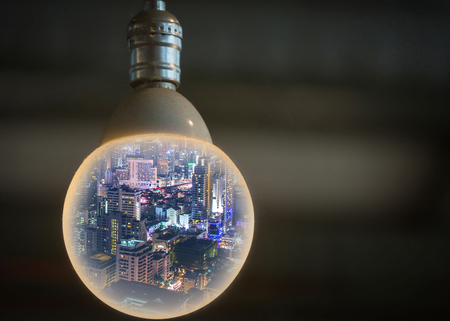 night cityscape in the big circle light bulb as business, globalization, think and idea concept.の写真素材