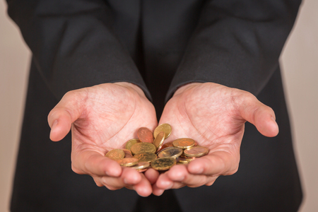 Businessman hand hold the euro coins as investment, income and saving concept.の写真素材