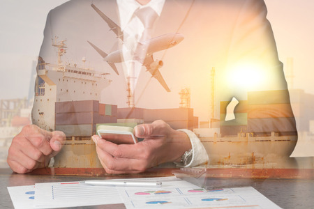 Double exposure of businessman working with smartphone, container cargo ship, cargo plane and airplane take off at sunset as business, communication, industrial and import export of logistic concept.の写真素材