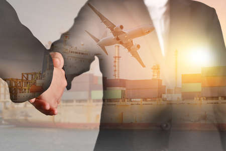 Double exposure of handshake, container cargo ship, cargo plane and airplane take off at sunset as business, commitment, industrial, transportation, logistic and import export concept.の写真素材