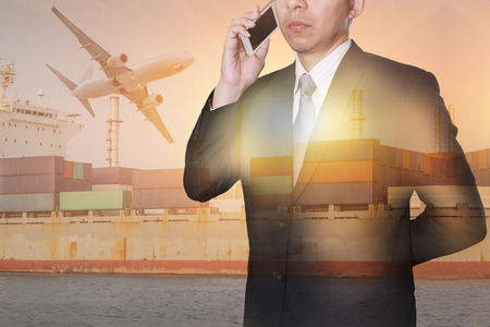 Double exposure of businessman calling with smartphone, container cargo ship, cargo plane and airplane as business, technology, telecommunication, industrial and import export of logistic conceptの写真素材