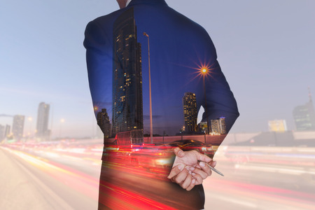 Double exposure of businessman think and analyze the work, light trails on the street and urban at dusk, night as business and vision of leader conceptの写真素材