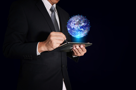 Businessman working with tablet and digital world as business, technology, innovation and globalization concept.の写真素材