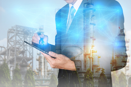 Double exposure of businessman hand hold tablet, digital light networking world mapの写真素材