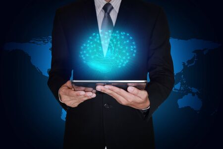 Double exposure of businessman hand hold tablet and blue glowing brain on world map background as...