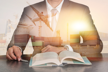 businessman sitting at meeting room to open the book, Container Cargo ship, Cargo plane and airplane take off at sunset as business, Learning, industrial, transportation and import export concept.の写真素材