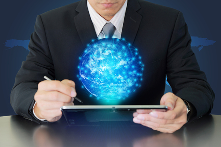 Double exposure of businessman working with tablet and glowing digital world as business, technology,の写真素材