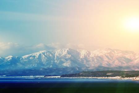 soft focus snow mountain with sunset in Hakodate, Hokkaido in Japanの写真素材