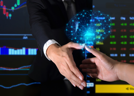 Double exposure of businessman will handshaking for business relationship and blue glowing polygon brain hologram as Commitment, Partnership, technology, brainstorm, investment and economy concept.の写真素材