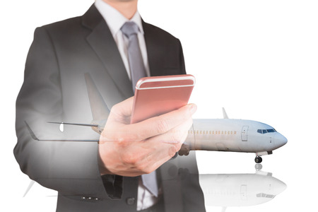 Double exposure of businessman holding and use Smartphone and airplant isolated white background as business, transportation, technology, communication and booking checkin conceptの写真素材