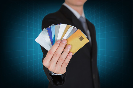 Businessman with many credit cards as the power to spend in your hands concept.の写真素材