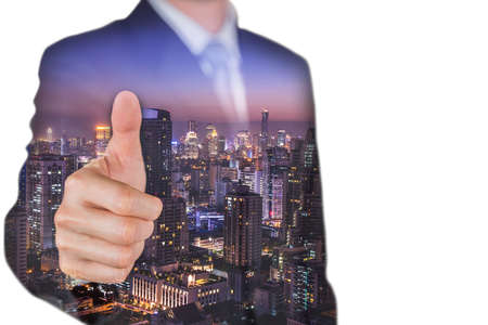Double exposure of businessman give a thumbs up for compliment and night cityscape as business, praise, congratulate, good and like conceptの写真素材