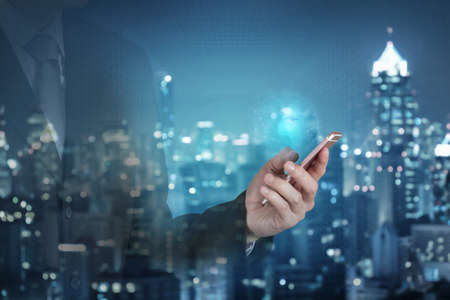 Double exposure of businessman use smartphone, blue world, communication 5G node networking...