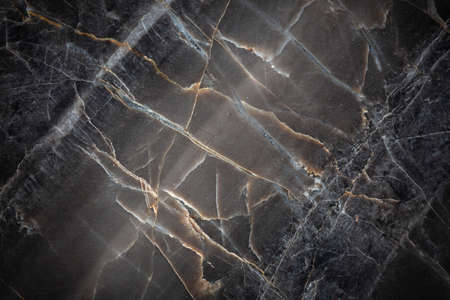 White and yellow patterned natural detailed of dark gray marble (Russia Gold) texture background for interior or product designの写真素材