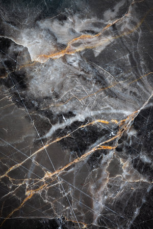 White and yellow patterned natural detailed of dark gray marble (Russia Gold) texture background for interior or product designの写真素材
