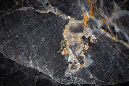 White and yellow patterned natural of dark gray marble (Russia Gold) texture  or backgroundの写真素材