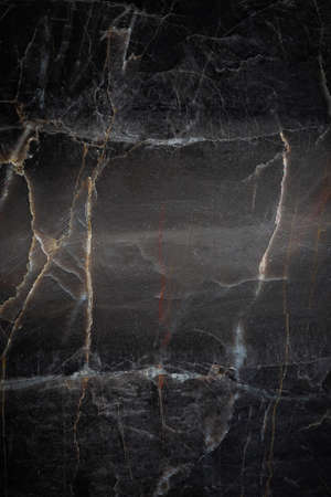 White and yellow patterned natural detailed of dark gray marble (Russia Gold) texture backgroundの写真素材