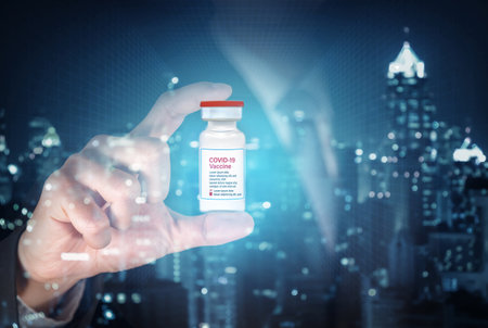 coronavirus vaccine or covid-19 vaccine inside the hand of the businessman as business idea concept.の写真素材