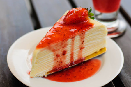 Crepe cake full with strawberry sauce with fresh strawberry on topの写真素材