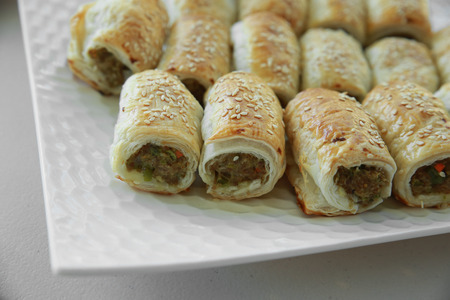 Homemade sausage rolls on white plateの写真素材