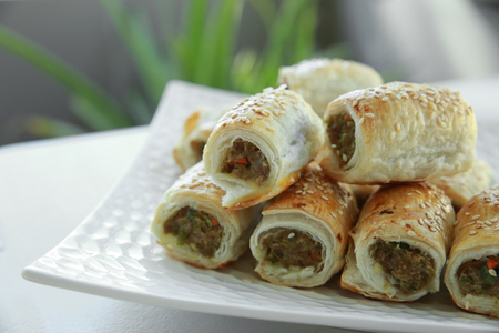 Homemade sausage rolls on white plateの写真素材