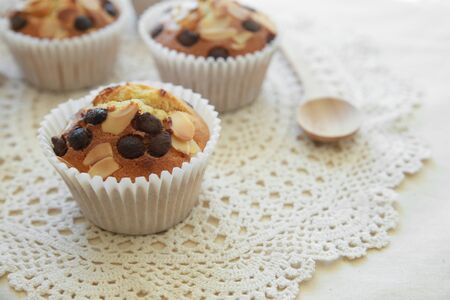 Homemade apricot chocolate chip almond slice muffins with spoonの写真素材