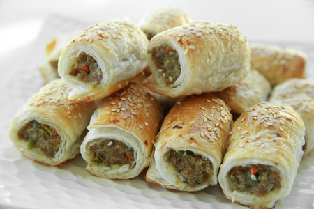 Homemade sausage rolls on white plateの写真素材