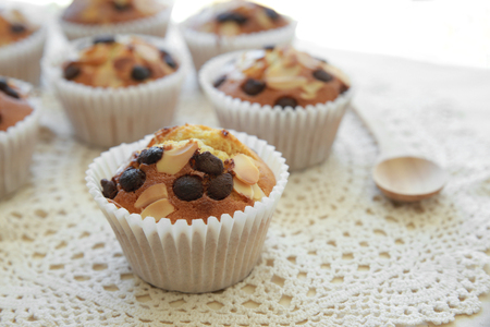 Homemade apricot chocolate chip almond slice muffins with spoonの写真素材
