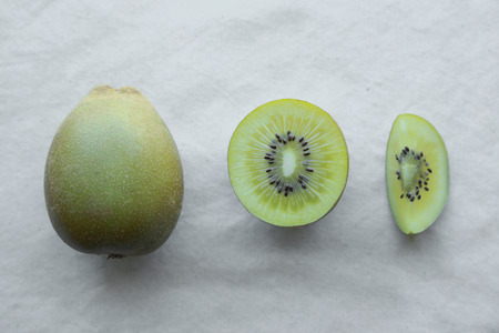 Slice half whole Gold Kiwifruitの写真素材