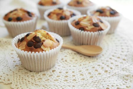 Homemade apricot chocolate chip almond slice muffins with spoonの写真素材