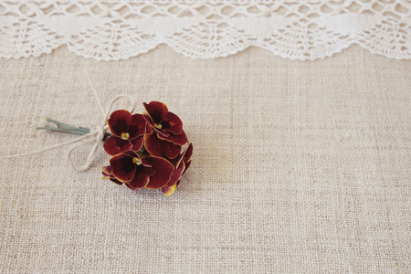 Red flowers on lace and linen, copy space background, selective focus, vintage toneの写真素材