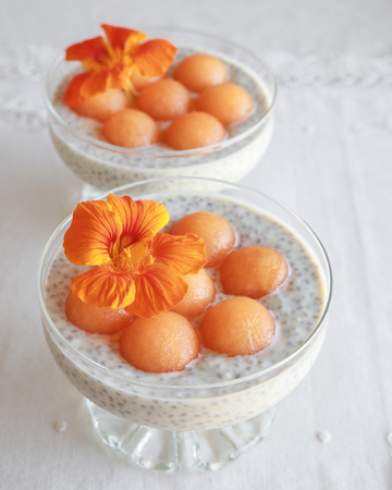 Chia seeds pudding with Cantaloupe balls garnished with orangeの写真素材