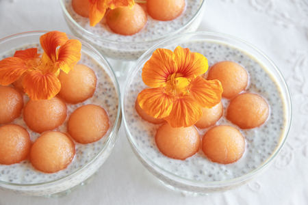 Chia seeds pudding with Cantaloupe balls garnished with orangeの写真素材