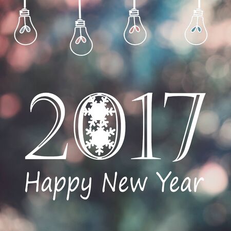 2017 Happy New Year and light bulbs with festive fairy light toning bokeh background