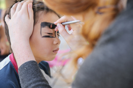 Young boy getting face painted