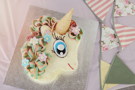 homemade rainbow unicorn cake with vintage bunting, toningの写真素材