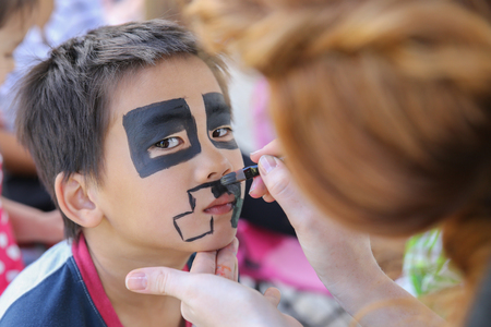 Young boy getting face painted