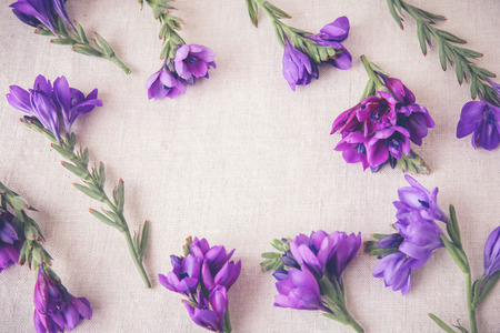 Purple flowers on linen toning copy space backgroundの写真素材