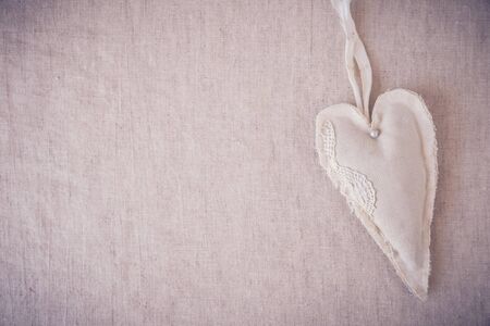 vintage linen heart on toning backgroundの写真素材