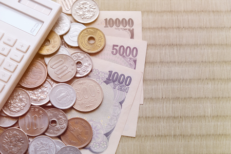 Japanese Yen money, banknotes, coins, calculator with copy space backgroundの写真素材