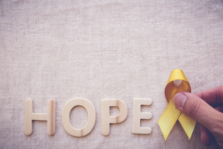 yellow gold ribbon with HOPE letters, Sarcoma Awareness, Bone cancer, Liver cancer, Bladder Cancer, childhood cancer awarenessの写真素材