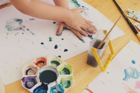 Kid hands painting on white paperの写真素材