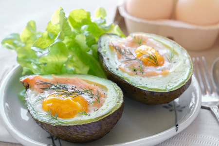 Baked smoked salmon, egg in avocado, ketogenic keto low carb diet foodの写真素材
