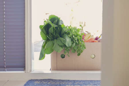 Grocery box at the door, delivering food box, supporting local business, donation conceptの写真素材